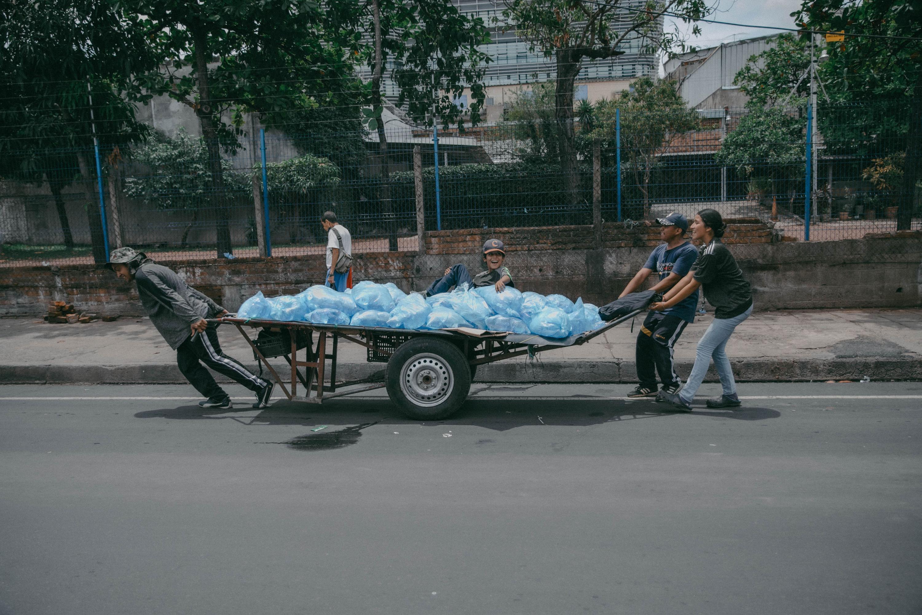 Los vendedores informales de El Centro llegaron a la Plaza Gerardo Barrios con carretones para recoger las bolsas de agua que quedaron al finalizar el evento de toma de posesión del presidente inconstitucional, Nayib Bukele. Foto de El Faro: Carlos Barrera