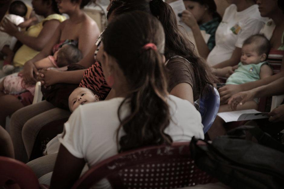 A group of pregnant teenagers and teen mothers participate in a conversation from the Young Adult Club in La Libertad. According to the health officials who run the club, all the pregnant teenagers have some sort of social issue stemming from their pregnancy or a history of family abuse. Photo by: Mauro Arias
